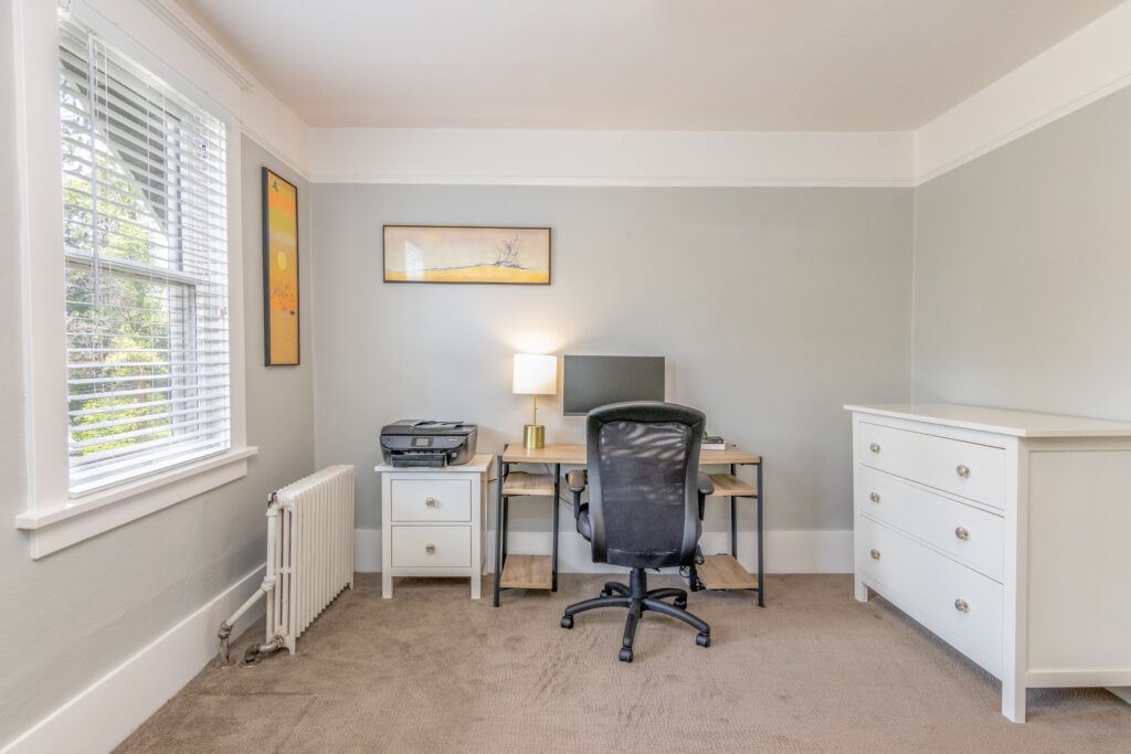 A bright and simple home office with sleek furniture and decor, perfect for productivity.